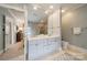 Bathroom featuring double sinks with gold fixtures and a large mirror above the vanity at 1529 S Wendover Rd, Charlotte, NC 28211
