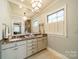 Bathroom showcasing dual sinks, marble countertops, and an elegant vanity mirror at 1529 S Wendover Rd, Charlotte, NC 28211