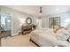 Bedroom with light blue walls, a bed with a patterned blanket, and a vanity area at 1529 S Wendover Rd, Charlotte, NC 28211