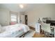 Bedroom featuring a bed with floral bedding, desk, and a door leading to another room at 1529 S Wendover Rd, Charlotte, NC 28211