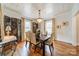 Elegant dining room with chandelier, hardwood floors, decorative screen, and natural light at 1529 S Wendover Rd, Charlotte, NC 28211