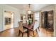 Refined dining room with chandelier, hardwood floors, stylish screen, and ample light at 1529 S Wendover Rd, Charlotte, NC 28211