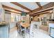 Bright kitchen with stainless appliances, wooden beams, an island, and an adjacent dining area at 1529 S Wendover Rd, Charlotte, NC 28211