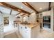 Spacious kitchen features a large island with range, wooden beams, and bright, white cabinets at 1529 S Wendover Rd, Charlotte, NC 28211