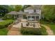 Backyard patio with built in grilling station, a large screened patio, and comfortable seating arrangement at 1529 S Wendover Rd, Charlotte, NC 28211