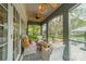 Charming screened porch with ceiling fans, comfortable seating, and views of the landscaped backyard at 1529 S Wendover Rd, Charlotte, NC 28211