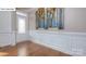 Elegant entryway featuring wainscoting, hardwood floors, and stylish wall art at 158 Ventor Way, Mooresville, NC 28115
