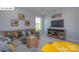 Relaxing living room with a gray sectional, TV, and a charming yellow table, perfect for entertainment at 158 Ventor Way, Mooresville, NC 28115