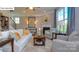 Comfortable living room featuring a fireplace, large windows, and stylish decor at 158 Ventor Way, Mooresville, NC 28115