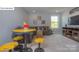Cozy living room featuring a comfortable gray sofa, quirky yellow table, and a wall-mounted television at 158 Ventor Way, Mooresville, NC 28115