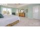 This primary bedroom is spacious with a decorative dresser and a large window providing natural light at 158 Ventor Way, Mooresville, NC 28115
