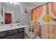 Stylish bathroom featuring a single sink vanity and a colorful shower curtain for a bright and modern look at 16038 Red Buckeye Ln, Huntersville, NC 28078