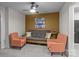 Versatile bonus room with a ceiling fan, futon, two chairs, and colorful wall decor for a relaxing space at 16038 Red Buckeye Ln, Huntersville, NC 28078