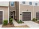 Inviting entrance with a dark wood door, stone accents, and a glimpse of the lovely interior details at 16038 Red Buckeye Ln, Huntersville, NC 28078