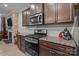 Chef's kitchen boasting stainless steel appliances, ample countertop space, and stylish dark wood cabinetry at 16038 Red Buckeye Ln, Huntersville, NC 28078