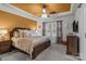 Luxurious main bedroom with a tray ceiling, a ceiling fan, and large windows offering plenty of natural light at 16038 Red Buckeye Ln, Huntersville, NC 28078
