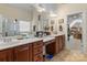 Bathroom featuring double sinks, a vanity area, and a walk-in closet at 16614 Ruby Hill Pl, Charlotte, NC 28278