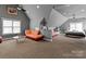 Spacious bedroom with gray walls, light brown carpeting, and seating areas for a relaxing retreat at 16614 Ruby Hill Pl, Charlotte, NC 28278