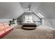 A unique bedroom has vaulted ceilings, plush carpeting, and a raised platform for the sleeping area at 16614 Ruby Hill Pl, Charlotte, NC 28278