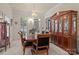 Formal dining area showcases a chandelier, large table, and ample storage at 16614 Ruby Hill Pl, Charlotte, NC 28278