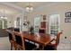 Formal dining area showcases a chandelier, large table, and ample natural light at 16614 Ruby Hill Pl, Charlotte, NC 28278