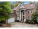 Classic brick home boasts a spacious driveway and attached two-car garage at 16614 Ruby Hill Pl, Charlotte, NC 28278
