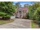 Elegant brick home features classic architectural details and a well-manicured front lawn at 16614 Ruby Hill Pl, Charlotte, NC 28278