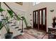 Grand foyer features a staircase, hardwood floors, and a statement front door at 16614 Ruby Hill Pl, Charlotte, NC 28278