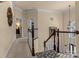 Bright hallway with wood railings and views into adjacent rooms at 16614 Ruby Hill Pl, Charlotte, NC 28278