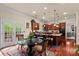 Open-concept kitchen with cherry wood cabinetry, granite counters and adjacent breakfast nook at 16614 Ruby Hill Pl, Charlotte, NC 28278