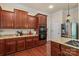 Modern kitchen featuring rich wood cabinetry, granite counters and stainless appliances at 16614 Ruby Hill Pl, Charlotte, NC 28278