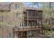 Brick home with multiple decks and a screened porch surrounded by lush trees, providing privacy at 16614 Ruby Hill Pl, Charlotte, NC 28278