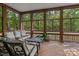 Relaxing screened porch with comfortable seating, perfect for enjoying the wooded surroundings at 16614 Ruby Hill Pl, Charlotte, NC 28278