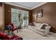 Cozy sitting area features neutral tones, comfortable seating, and ample natural light at 16614 Ruby Hill Pl, Charlotte, NC 28278