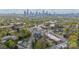 An aerial perspective shows Charlotte's skyline, surrounded by lush trees and charming residential streets at 1933 W Trade St, Charlotte, NC 28216