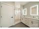 Stylish bathroom features double vanity, modern fixtures, and a glass-enclosed shower with decorative tile flooring at 1933 W Trade St, Charlotte, NC 28216