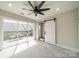 Carpeted bedroom with ceiling fan features sliding glass doors to an outdoor patio at 1933 W Trade St, Charlotte, NC 28216