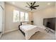Neutrally decorated bedroom features a ceiling fan, large window, and carpeted floor at 1933 W Trade St, Charlotte, NC 28216