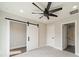 Carpeted bedroom features an ensuite bathroom and a sliding barn door at 1933 W Trade St, Charlotte, NC 28216