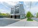 Modern townhome with gray siding, glass garage doors, and a well-kept exterior in a residential neighborhood at 1933 W Trade St, Charlotte, NC 28216