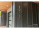 Close-up showcasing the house number '1933' on a modern exterior with wood ceiling and sleek design at 1933 W Trade St, Charlotte, NC 28216