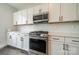 Modern kitchen with white cabinets, stainless steel appliances, and gas range at 1933 W Trade St, Charlotte, NC 28216