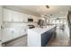 Modern kitchen with white cabinets, stainless steel appliances, and large island at 1933 W Trade St, Charlotte, NC 28216