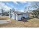 A look at the back of a light blue brick home featuring a chimney and air conditioning unit at 200 W Shannonhouse St, Shelby, NC 28152