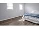 Bedroom with hardwood flooring, a neutral color palette, and bed with blue accents at 200 W Shannonhouse St, Shelby, NC 28152