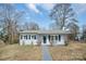 Charming single-story home with freshly painted exterior and well-manicured front lawn at 200 W Shannonhouse St, Shelby, NC 28152
