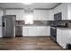 Modern kitchen features stainless steel appliances and ample cabinet space at 200 W Shannonhouse St, Shelby, NC 28152