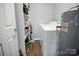 Compact laundry room with shelving, washer, and space-saving water heater at 200 W Shannonhouse St, Shelby, NC 28152