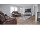 Inviting living room with hardwood floors, two loveseats, and a large TV at 200 W Shannonhouse St, Shelby, NC 28152