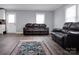 Inviting living room with hardwood floors, two loveseats, and a large TV at 200 W Shannonhouse St, Shelby, NC 28152
